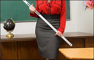 Busty teacher Sara Jay in black pantyhose strips in the classroom