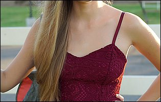 Young cutie Alyce Anderson in sexy dress poses outdoor