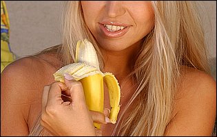 Lovely blonde Anette Dawn posing and playing with banana