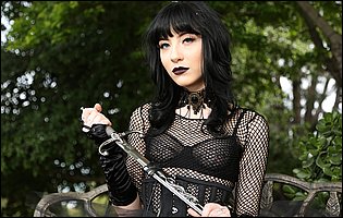 Charlotte Sartre in sexy black outfit poses outdoor