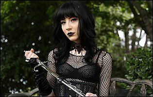 Charlotte Sartre in sexy black outfit poses outdoor