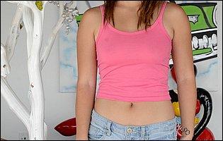 Daisy Haze strips off her pink t-shirt and denim shorts