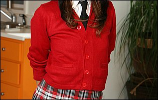 Danni Cole in school uniform strips for camera