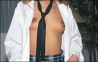 Jeanie Rivers in school uniform strips for camera