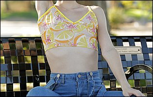 Jessie Saint in sexy top and blue jeans poses outdoor.