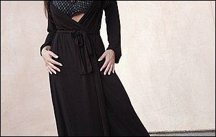 Gorgeous brunette Lisa Ann posing in black nylons and high heels