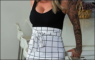 Lolly Dames strips off her sexy outfit and poses nude on couch