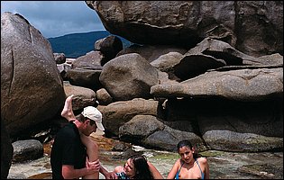 Lucie Lee and Jennifer Dark posing and fucking with a horny guy on the beach