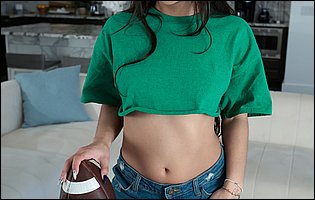 Madison Wilde posing in green top and denim shorts