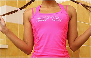 Malena Tara in pink t-shirt, panties and high heels posing in the bathroom