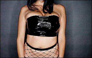 Missy Martinez posing in black latex top and fishnet stockings