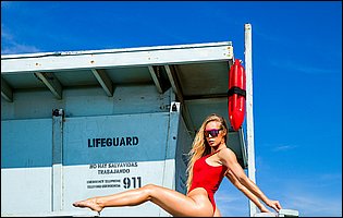 Nicole Aniston posing in red bathing suit