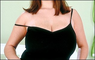 Busty beauty Nicole Peters in black stockings and sexy heels loves to tease