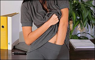Young business woman Ruth Medina stripping in the office