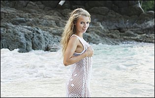 Pretty blonde Stella Lane poses on the beach