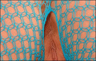 Sylvie Sinner in blue fishnet toying her asshole