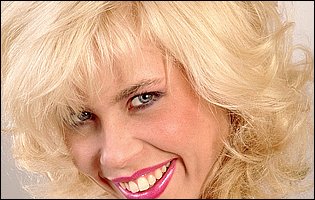 Big boobed blonde MILF Tiffany Tower poses in white stockings and heels