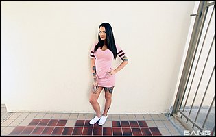 Sexy brunette Trinity Blaze in pink dress and white sneakers stripping and teasing