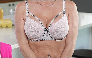 Wendy Raine in pink dress and black stockings strips for camera